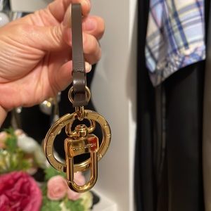 Louis Vuitton brown with gold keychain/strap .Can be used as a keychain/handle